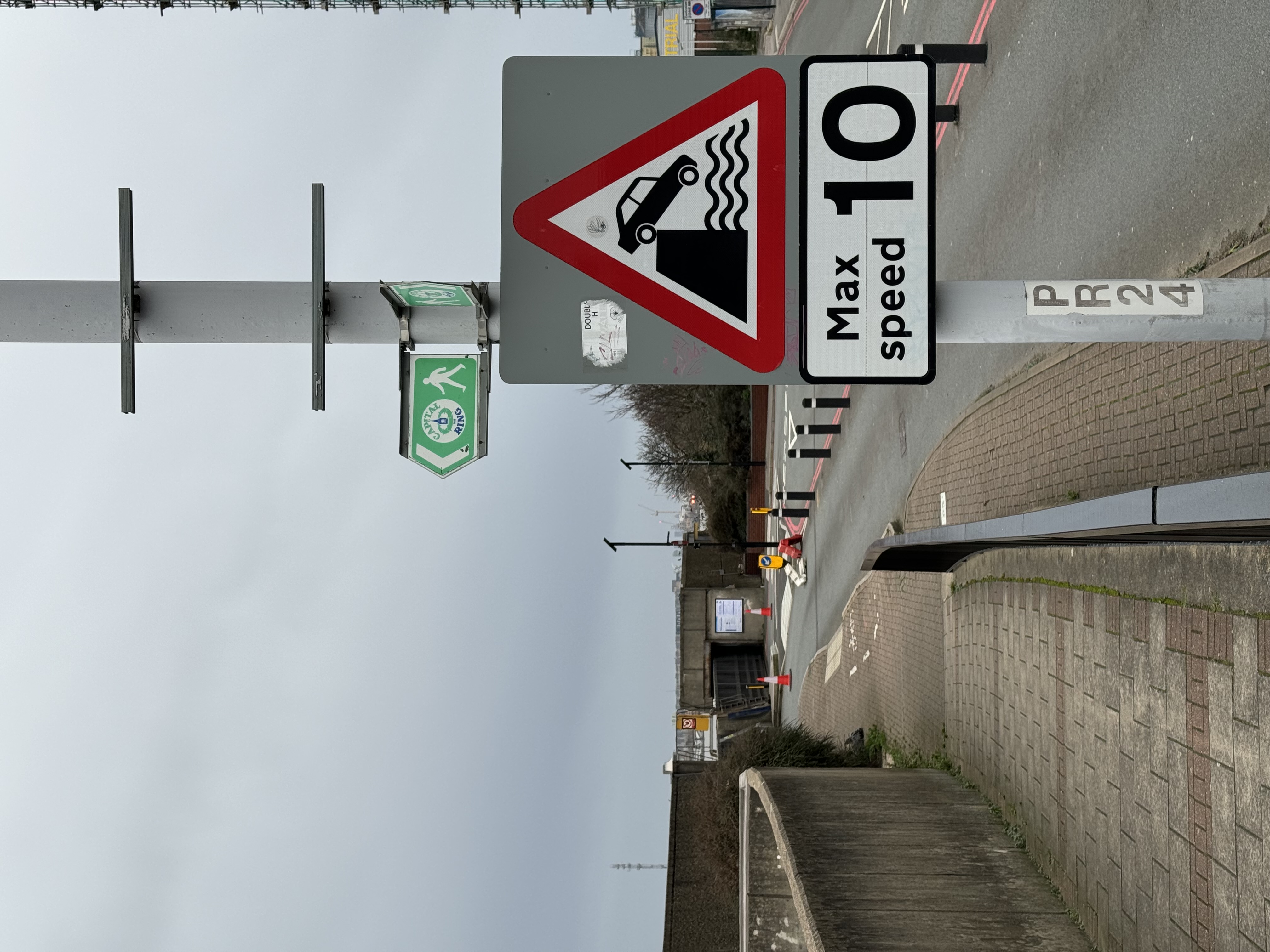 A road sign showing a car falling off a pier into the Thames