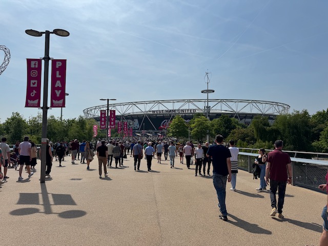 Outside of London Stadium with fans walking towards the stadium to attend the match