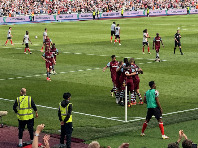 West Ham players celebrating a goal in the corner of the pitch