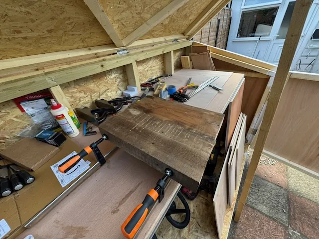 Two pieces of wood being glued together to form the guitar body.