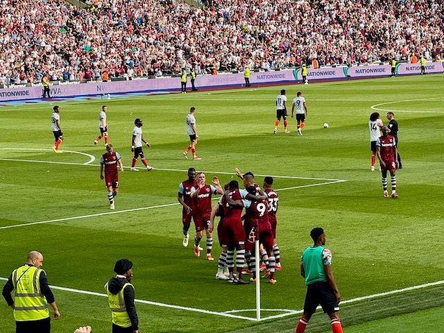 West Ham United players celebrating in the corner after scoring a goal