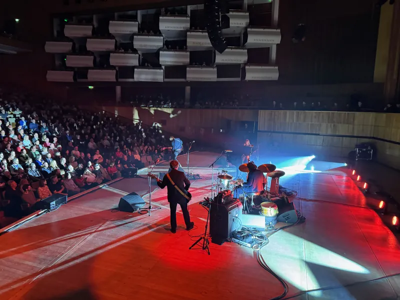 Wider shot of the stage where the audience is in the shot.