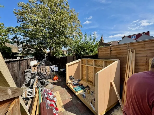 The initial framing of the woodworking workbench, showing the base and vertical supports.