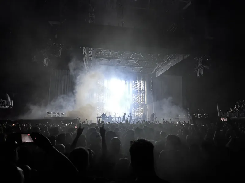 A flood of white light and smoke pouring off the main stage
